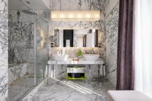 a bathroom with two sinks and a mirror at Mandarin Oriental, Milan in Milan