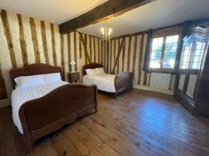 a bedroom with a bed and a chair and windows at Guest House, Private Pool in LʼIsle-en-Dodon