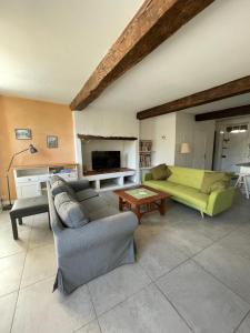 a living room with a couch and a table at Guest House, Private Pool in LʼIsle-en-Dodon +12 photos