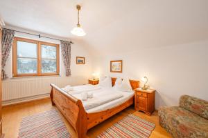 a bedroom with a bed and a couch and a window at Stanglhof - by myNests in Bad Aussee