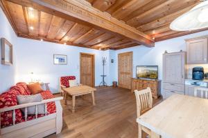 a living room with a couch and a table at Stanglhof - by myNests in Bad Aussee