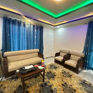 a waiting room with a couch and a table at A Cube Homestay in Bharatpur