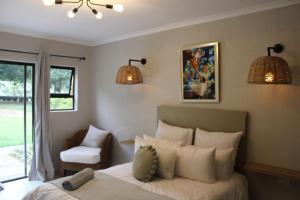 a bedroom with a bed and a chair and lights at The White Castle in Chartwell