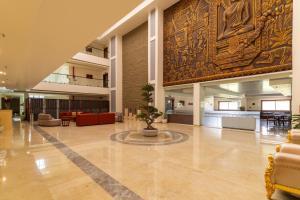a large lobby with a large rug on the wall at Omkar Jungle Resort & Spa, Sirsi in Islūr