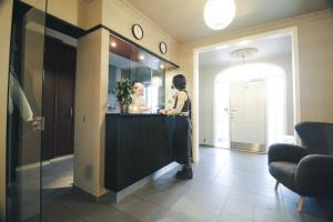 a woman standing at a counter in a room at Nupan Deluxe in Keflavík +62 photos