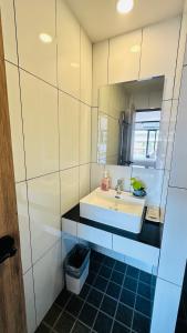 a bathroom with a sink and a mirror at Oh'tel Kata in Kata Beach +17 photos