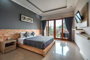 a bedroom with a bed and a large window at D Sarian Seminyak in Seminyak +21 photos