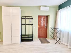 a room with two doors and a red door at Dunes Trail 2 in Melnragė