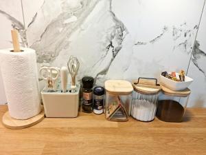 a bunch of kitchen utensils on a wooden shelf at Dunes Trail 2 in Melnragė