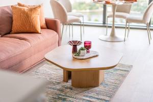 a living room with a couch and a coffee table at Queens Wharf 1B plus Study apt - level 29 City view in Brisbane