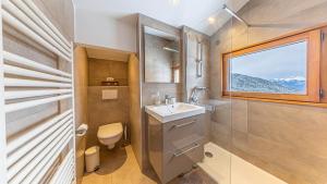 a bathroom with a sink and a toilet and a window at Atalaya Chalet - Panoramic View in Saint-Jean-de-Sixt +55 photos