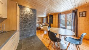 a kitchen and dining room with a table and chairs at Atalaya Chalet - Panoramic View in Saint-Jean-de-Sixt