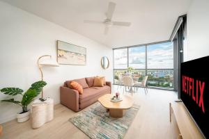 a living room with a couch and a table at Queens Wharf 1B plus Study apt - level 29 City view in Brisbane