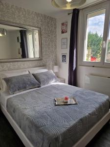 a bedroom with a bed with a tray on it at Le Peekskill in Montbron