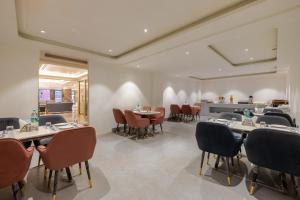 a restaurant with tables and chairs in a room at Hotel The Janak By Shanti Near New Delhi Train Station , New Delhi in New Delhi