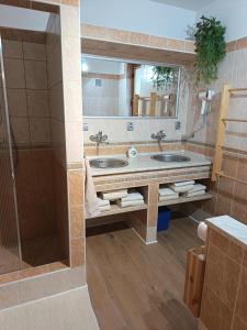 a bathroom with two sinks and a shower at Privát NA CHALUPE Partizánska Ľupča 649 in Partizánska ľupča +48 photos
