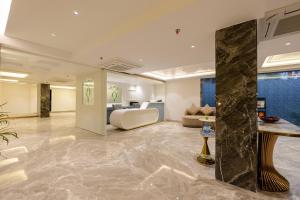 a hotel lobby with a bed and a couch at Hotel The Janak By Shanti Near New Delhi Train Station , New Delhi in New Delhi