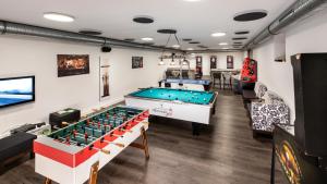 a billiard room with a pool table and chairs at Sporthotel Bernrieder Hof GmbH in Bernried