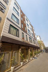 a building with potted plants in front of it at Hotel The Janak By Shanti Near New Delhi Train Station , New Delhi in New Delhi
