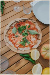 a pizza sitting on top of a wooden table at Vino Resort Son Amaret in Son Macia