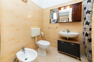 a bathroom with a toilet and a sink at Villetta Degli Aranci in San Foca +29 photos