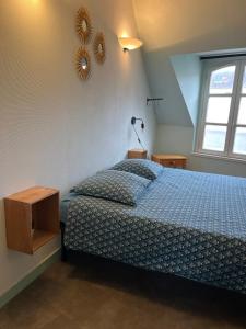 a bedroom with a bed and a mirror on the wall at studio 3- les moulins in Cherbourg en Cotentin