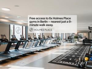 a gym with rows of treadmills and a sign at Numa Berlin Boxer in Berlin