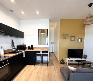 a kitchen and living room with a table and a couch at Cozy Studio with Terrace in Cers