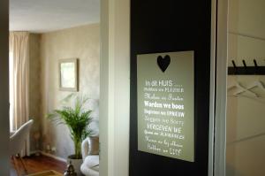 a room with a door with a sign on it at Casa Vista Duna - Kijkduin in The Hague +22 photos