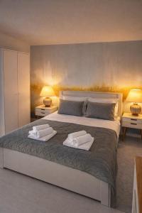 a bedroom with a large bed with two towels on it at Villa Una Maris - renovated 2026 in Pag