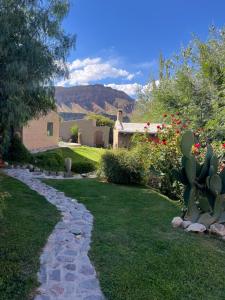 a garden with a stone path in front of a house at Casa Domo Juella in Juella