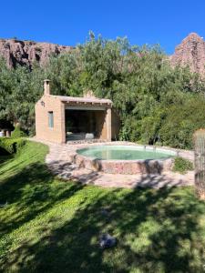 a small pool in a yard with a house at Casa Domo Juella in Juella