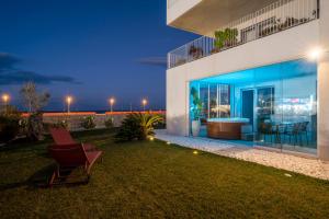 a house with a yard with a chair in front of it at Villa fronte mare in Bari