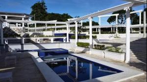 a swimming pool in front of a white house at IT Farm Resort in Rizal +9 photos