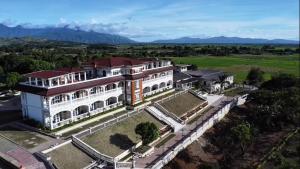 an aerial view of a large white building with a yard at IT Farm Resort in Rizal