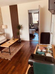 a living room with a couch and a table at Casa Vista Duna - Kijkduin in The Hague