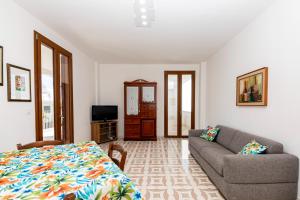 a living room with a bed and a couch at Il Bacio del Sole - San Foca in San Foca