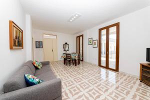 a living room with a couch and a table at Il Bacio del Sole - San Foca in San Foca