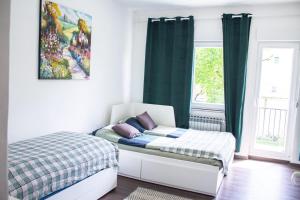 a small bedroom with a bed and a window at Apartman Gajnice Zagreb in Zagreb