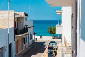a view of the ocean from the balcony of a building at Il Bacio del Sole - San Foca in San Foca