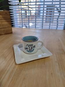 a coffee cup on a saucer on a table at LOFT La Placeta in Enguera +8 photos
