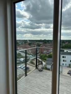 a balcony with a view of a parking lot at Beach View Apartment in Vallensbæk in Vallensbæk +6 photos