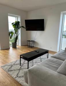 a living room with a couch and a coffee table at Beach View Apartment in Vallensbæk in Vallensbæk