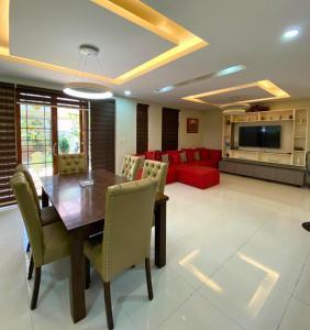 a dining room with a table and chairs and a couch at Rathore villa in Lahore