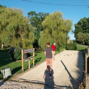 a man is walking down a driveway at Gite de la Jument grise-calme et tranquillité in Lescheroux