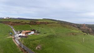an aerial view of a house on a green hill at Finca Seles in Ajo