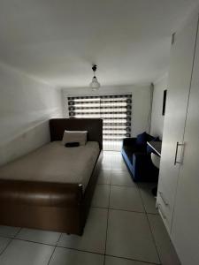a living room with a couch and a window at Sunset Rest Guesthouse in Secunda