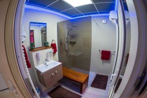 a bathroom with a shower and a sink at E14 apartman in Berekfürdő