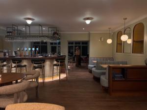 a bar in a restaurant with tables and chairs at Lyzzick in Keswick
