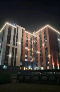 a large building at night with lights on it at 1 комнатные апартаменты 4а 67 in Semey